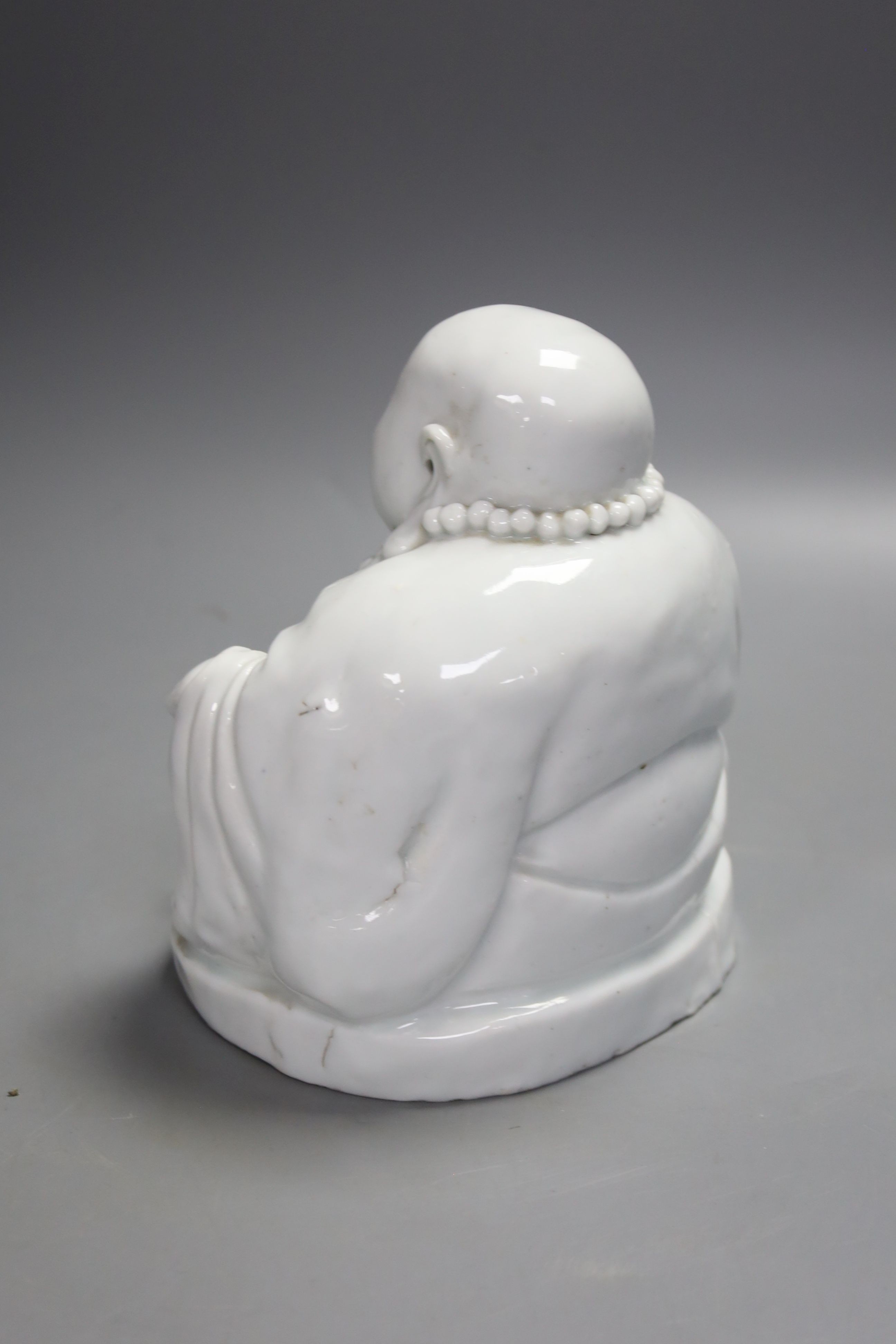 A Chinese blanc de chine porcelain model of Budai, height 16cm